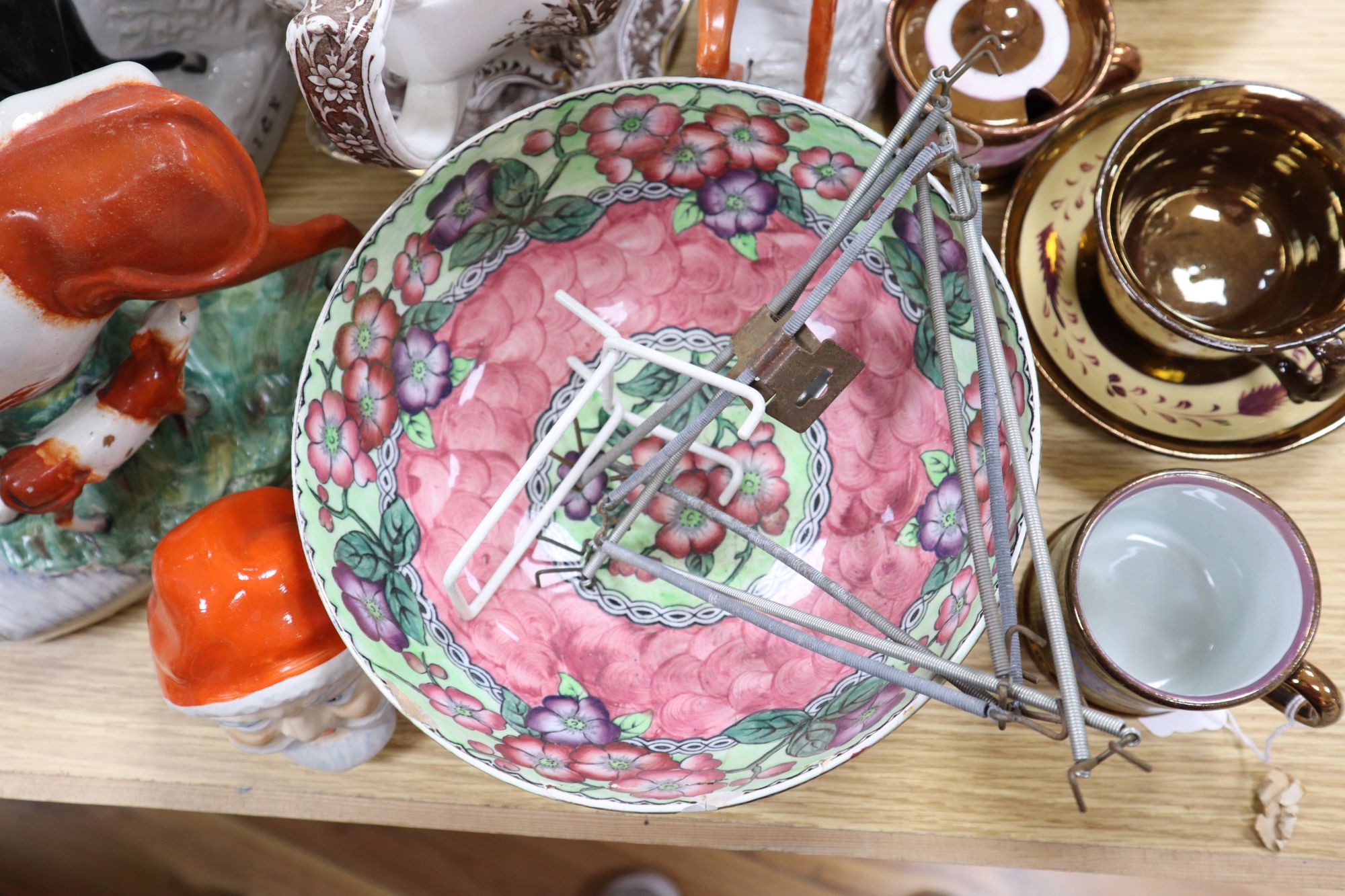A group of Staffordshire pottery figures, teapots and lustre wares